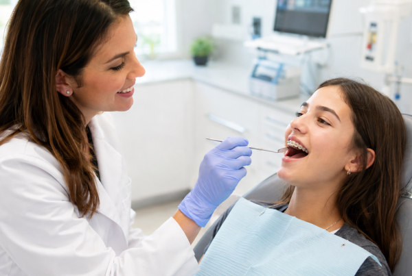 Orthodontist examining a patient's bite at a modern orthodontic office in Alexandria, VA